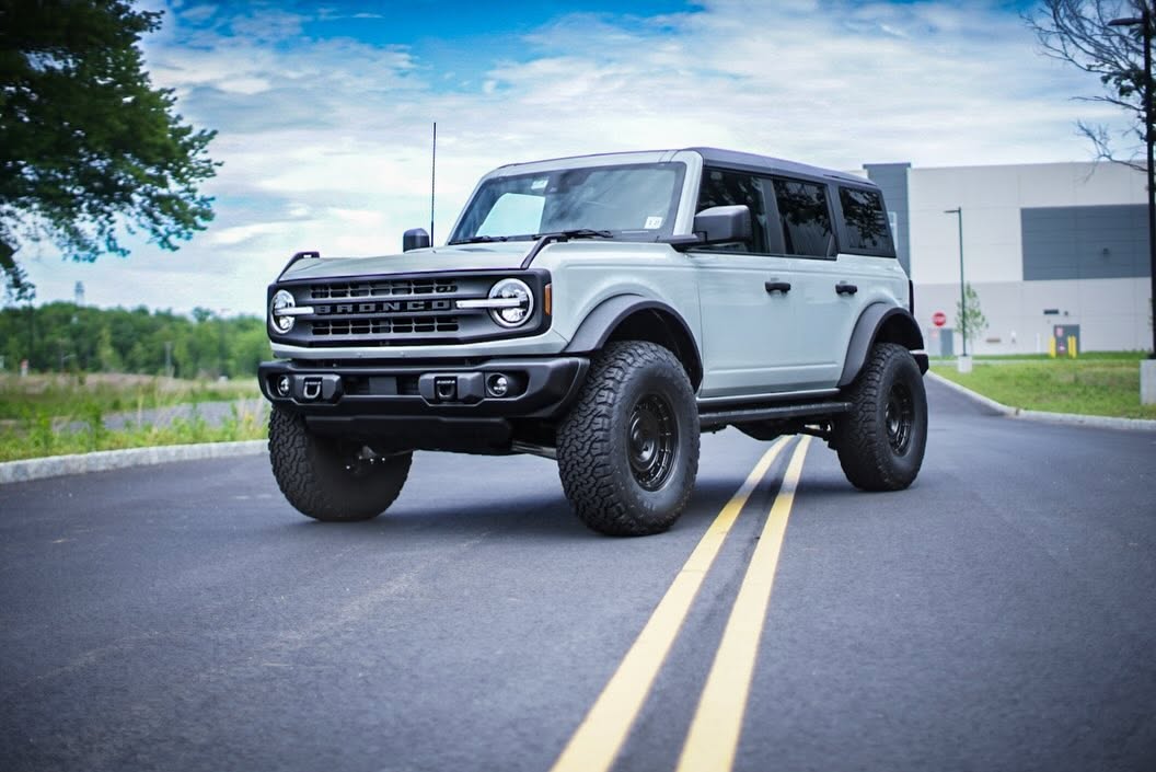 Grey Ford Bronco on a wet road