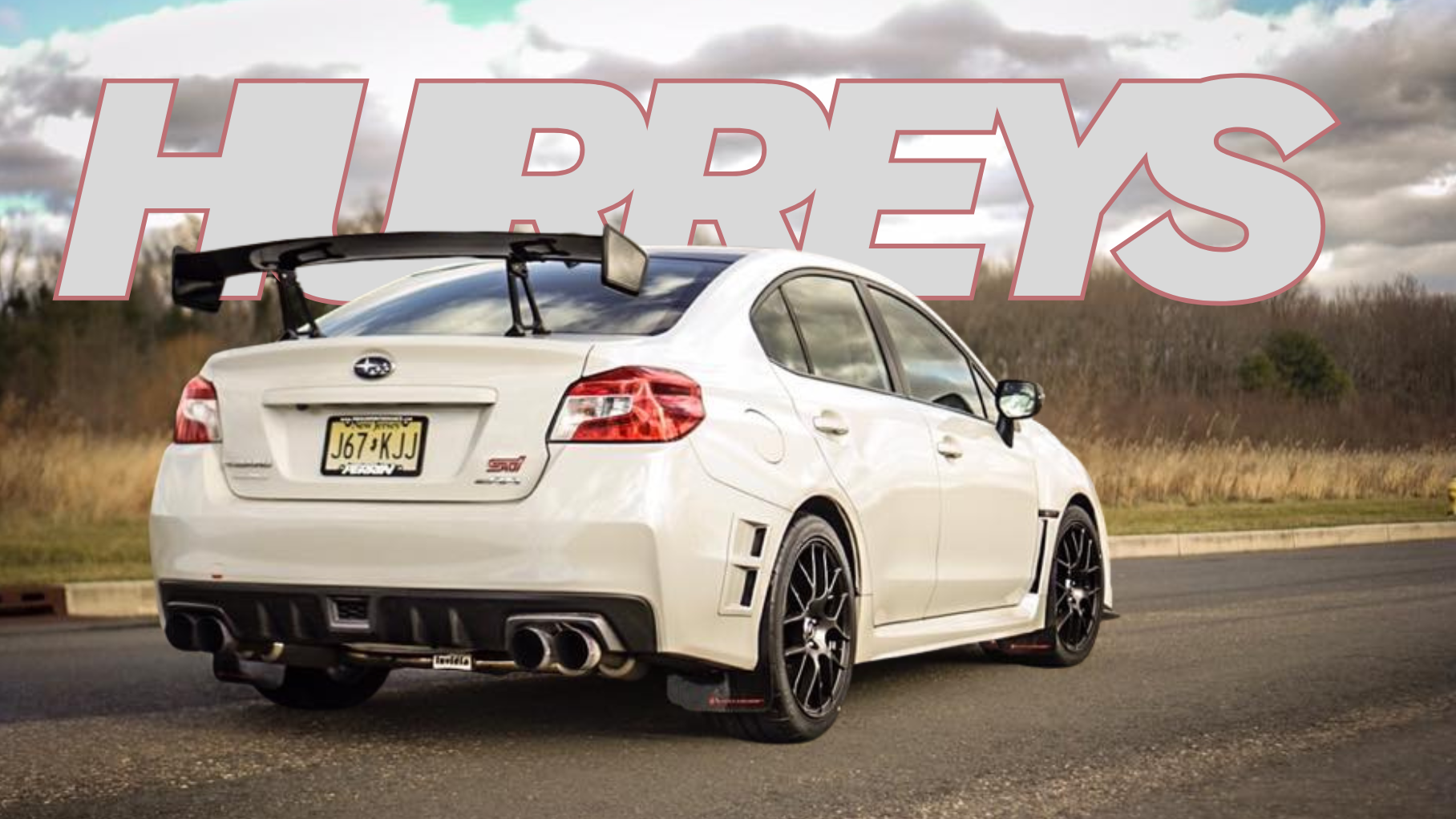 White Subaru WRX with a large 'HUPREYS' logo in the background