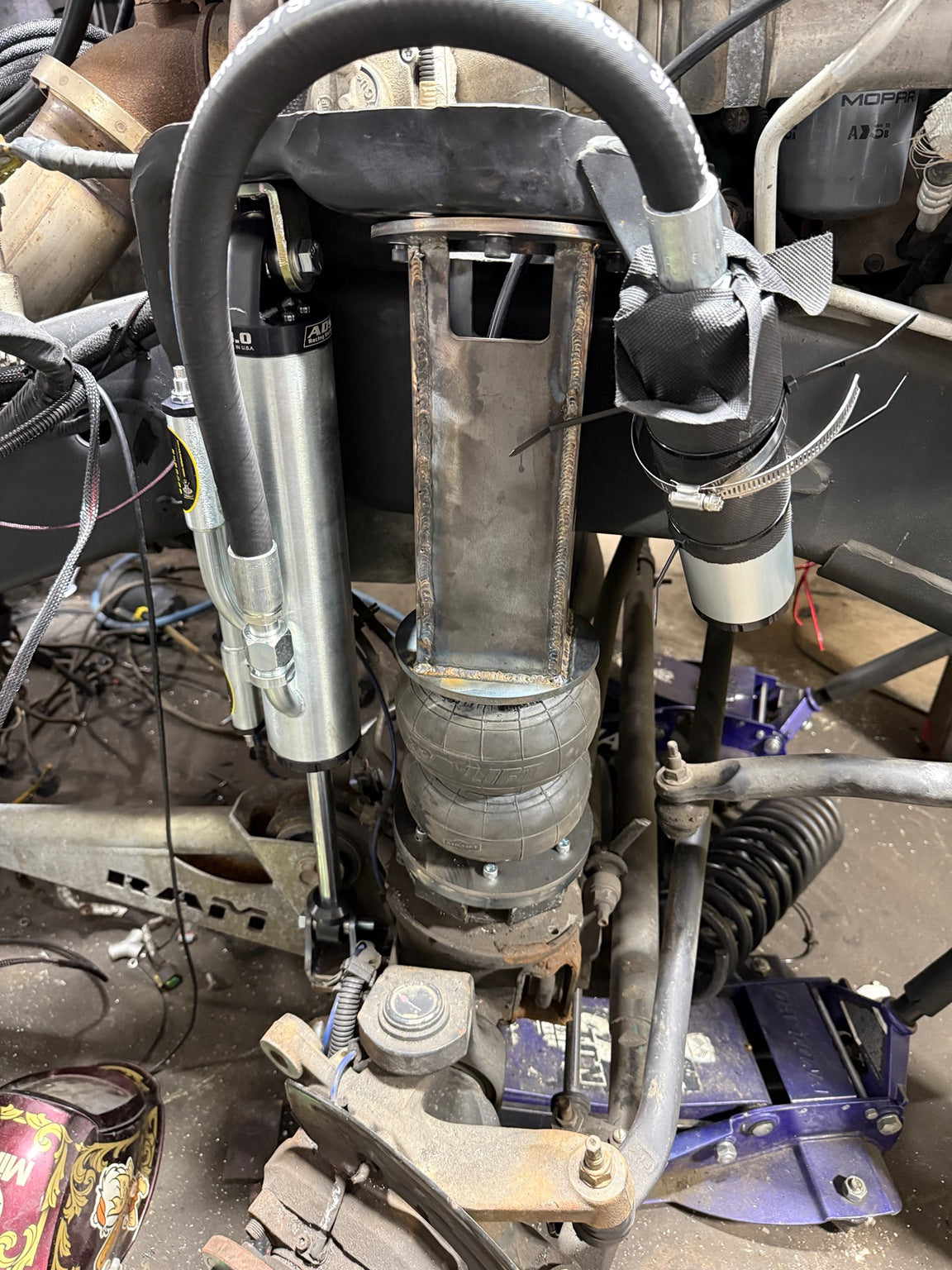 Close view of fabricated front air spring mount, ADS shock and reservoir fitment.