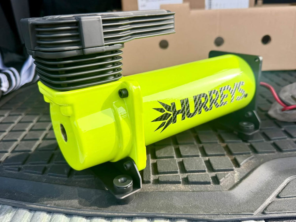 Custom neon yellow air compressor with Hurrey’s branding.
